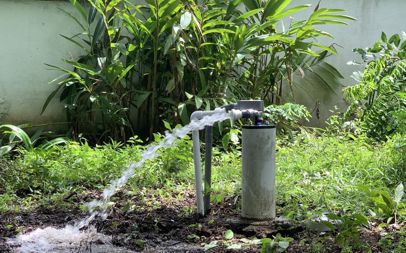 Wellhead flushing water to the ground, away from the house